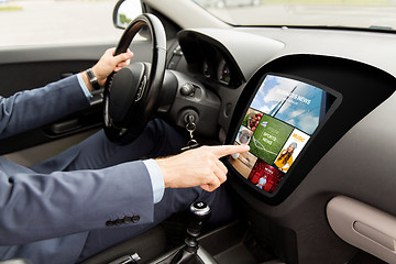 Image showing man driving car with news on board computer