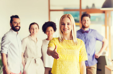 Image showing woman making handshake over creative office team