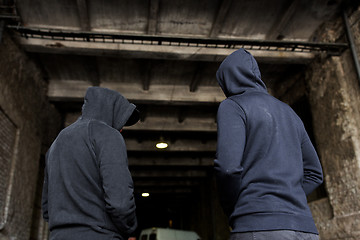 Image showing addict men or criminals in hoodies on street