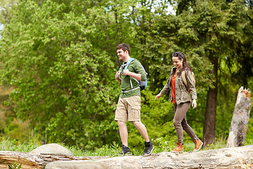 Image showing happy couple with backpacks hiking outdoors