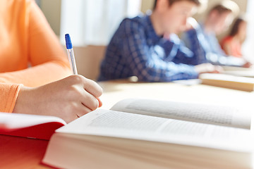 Image showing close up of students with book writing school test