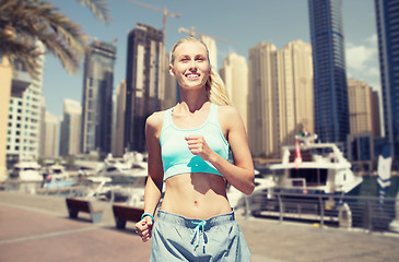 Image showing woman running or jogging over dubai city street