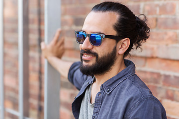 Image showing happy smiling man with beard on city street