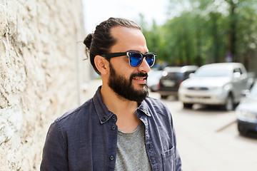 Image showing happy smiling man with beard on city street