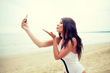 Image showing young woman taking selfie with smartphone