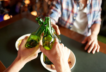 Image showing close up of friends drinking beer at bar or pub