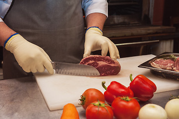 Image showing Chef cutting meat