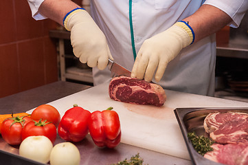 Image showing Chef cutting meat