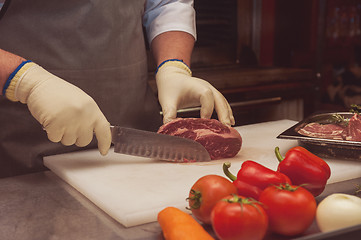 Image showing Chef cutting meat