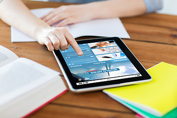 Image showing close up of student with tablet pc and notebook