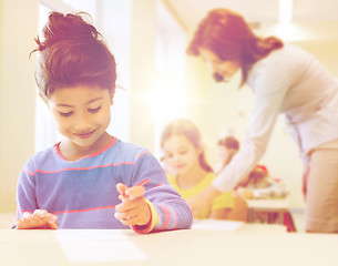 Image showing happy little school girl over classroom background