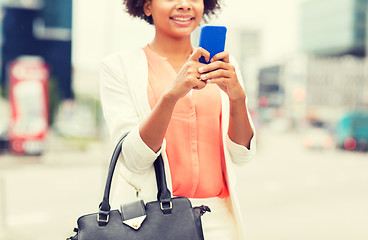 Image showing close up of african woman with smartphone in city