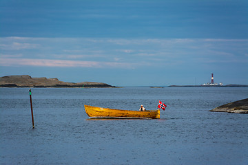 Image showing Seascape - Ferder lighthouse and wooden boat