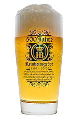 Image showing Glass cold Bavarian beer with frothy foam head backlit isolated