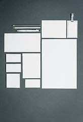 Image showing Mock-up business template with cards, papers, pen. Gray background.