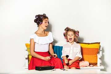 Image showing Little girl playing with her mom\'s makeup