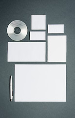 Image showing Mock-up business template with cards, papers, disk. Gray background.