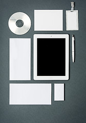 Image showing Mock-up business template with cards, papers, tablet. Gray background.