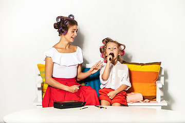 Image showing Little girl playing with her mom\'s makeup