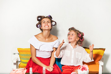 Image showing Little girl sitting with her mother and playing