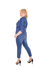 Image showing Woman in jeans clothing standing.