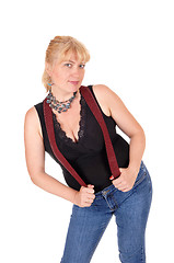 Image showing Pretty woman standing with suspenders.