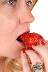 Image showing Closeup woman eating strawberry.