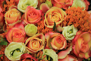 Image showing Orange and yellow roses in a bridal bouquet