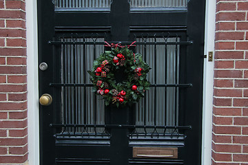 Image showing Traditional Christmas wreath on a glass door