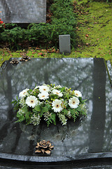 Image showing Funeral flowers on a tomb