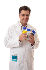 Image showing Laboratory chemist holding bottles of chemicals