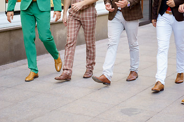 Image showing Group of stylish men walking down the street
