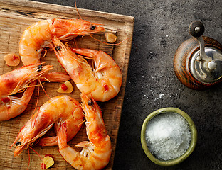 Image showing roasted prawns on wooden cutting board