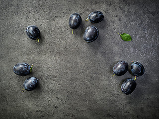 Image showing blue plums on dark background