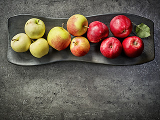 Image showing various fresh apples on black plate