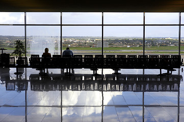 Image showing Two passengers waiting in airport lounge