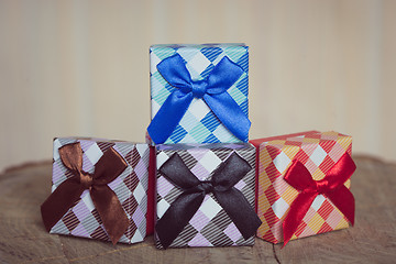 Image showing Gift box with blue bow on wood background