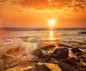 Image showing Waves and rocks on beach of sunset