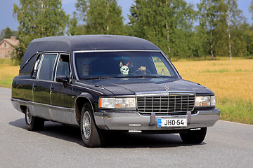 Image showing Cadillac Fleetwood Funeral Vehicle Driving Along Rural Road