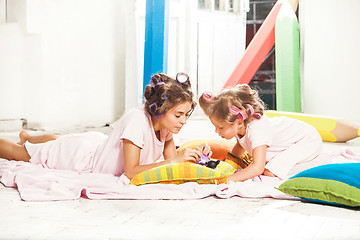 Image showing Little girl sitting with her mother and playing