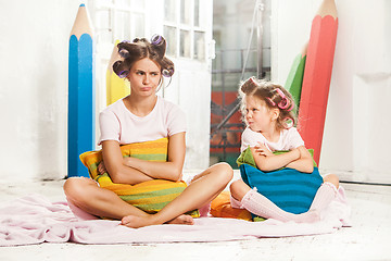 Image showing Little girl sitting with her mother
