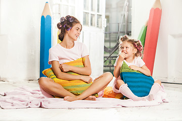 Image showing Little girl sitting with her mother and playing