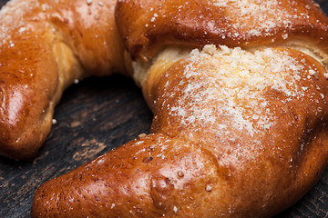 Image showing Tasty croissant on wooden background