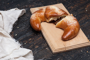 Image showing Tasty croissant on wooden background