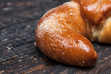 Image showing Tasty croissant on wooden background