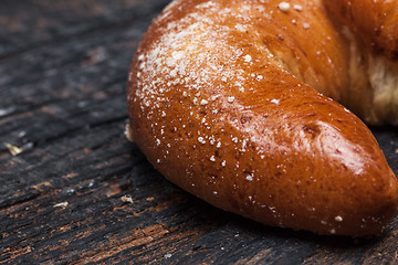 Image showing Tasty croissant on wooden background