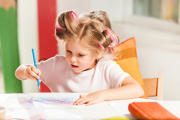 Image showing The young mother and her little daughter drawing with pencils at home