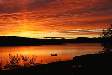 Image showing Red sky over mountain lake