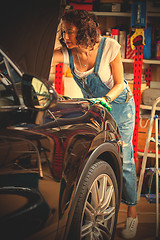 Image showing Mechanic woman opened the hood of the car