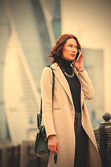 Image showing woman in a bright coat talking on the phone